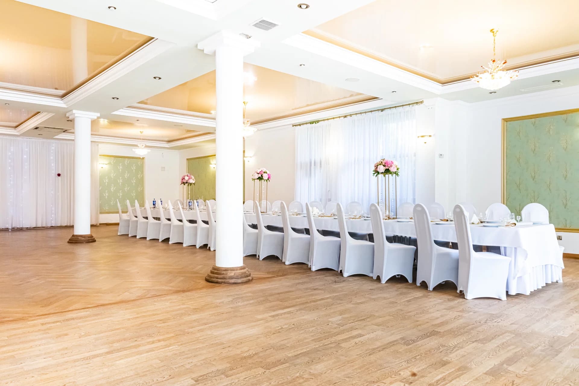 Sala weselna z białymi krzesłami w Zaciszu Zbiczno